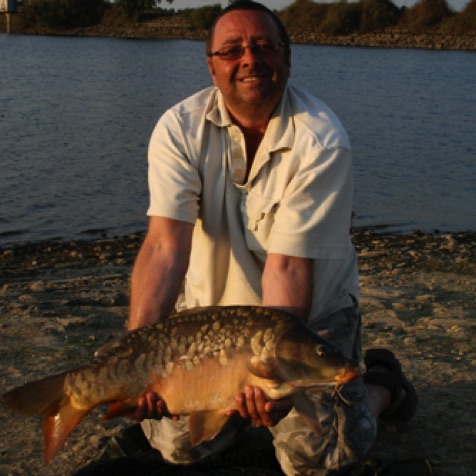 Terry - a regular visitor from England with a medium size carp Terry - a regular visitor from England with a medium size carp